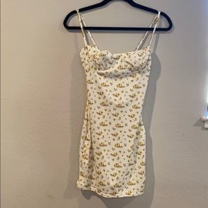 White mini dress with yellow floral pattern